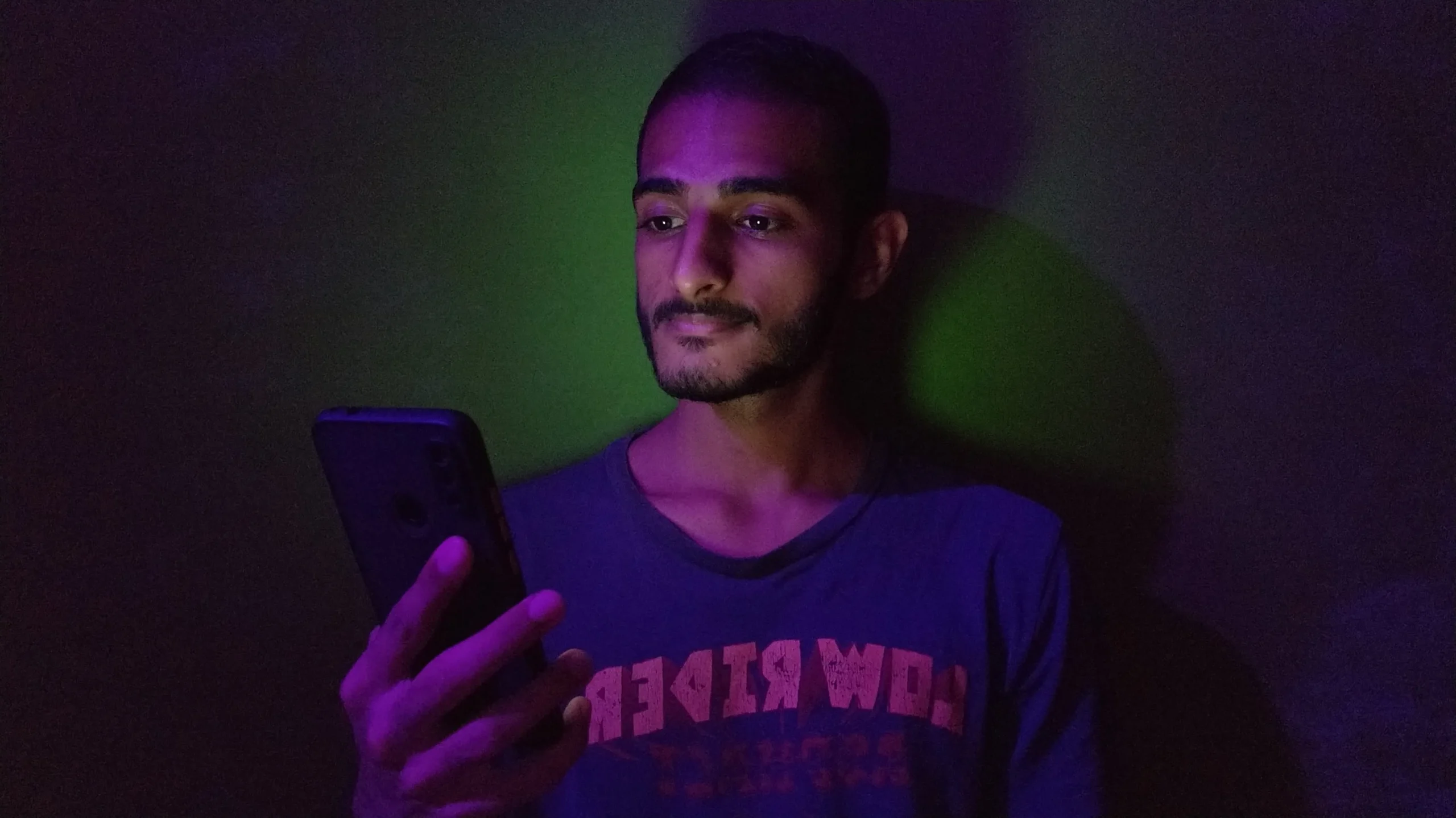 guy looking at his phone at night